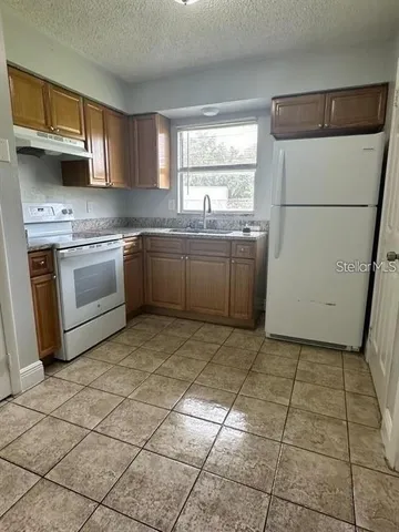 a view of a livingroom with wooden floor and a sink