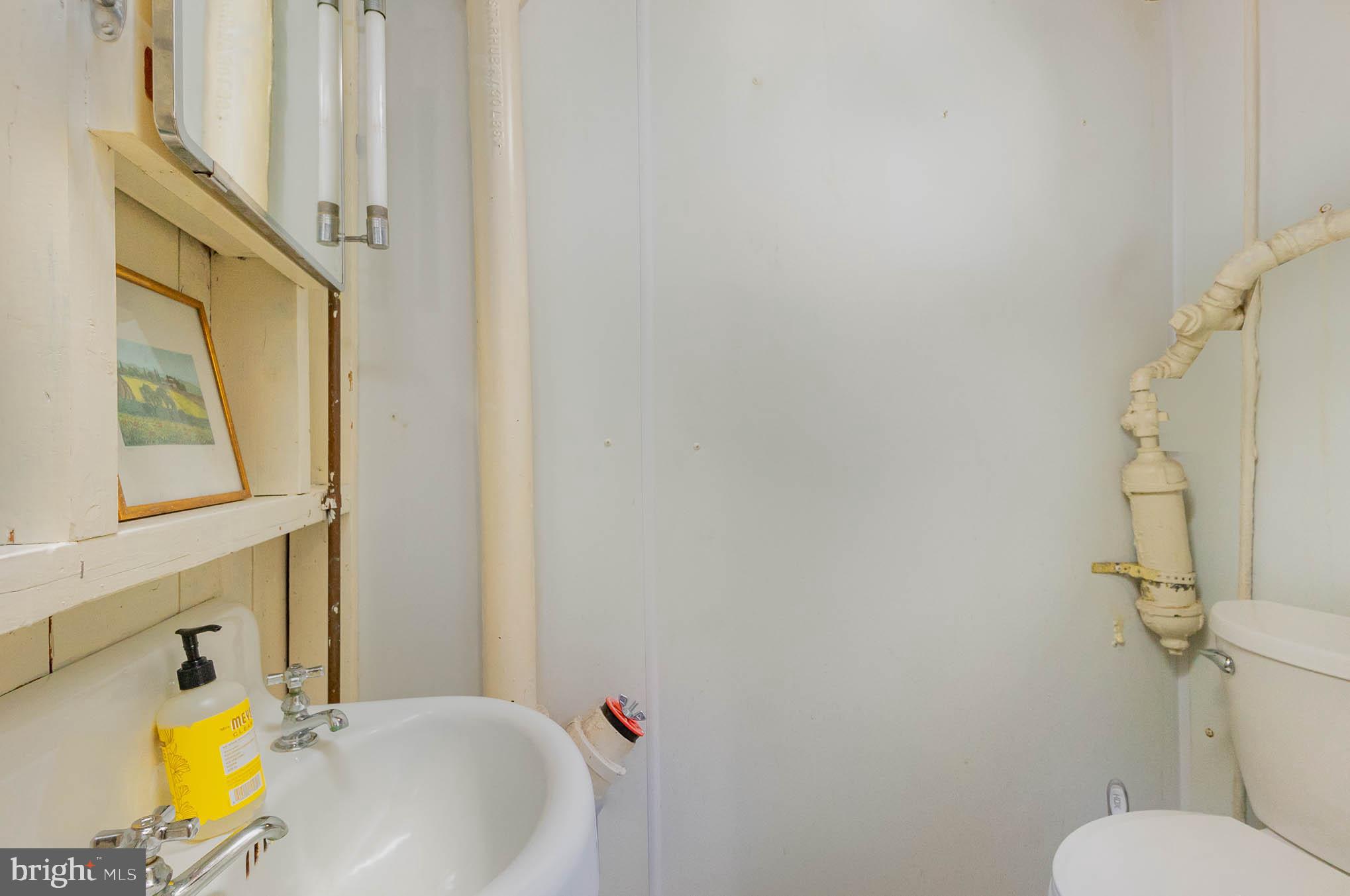 4032 Deepwood Road Baltimore, MD 21218 - Photo 26 of 31 a bathroom with a sink and a mirror