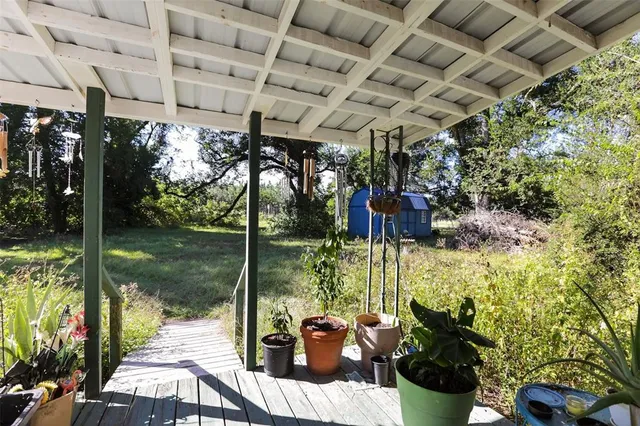 a view of a patio with table and chairs potted plants with sky view
