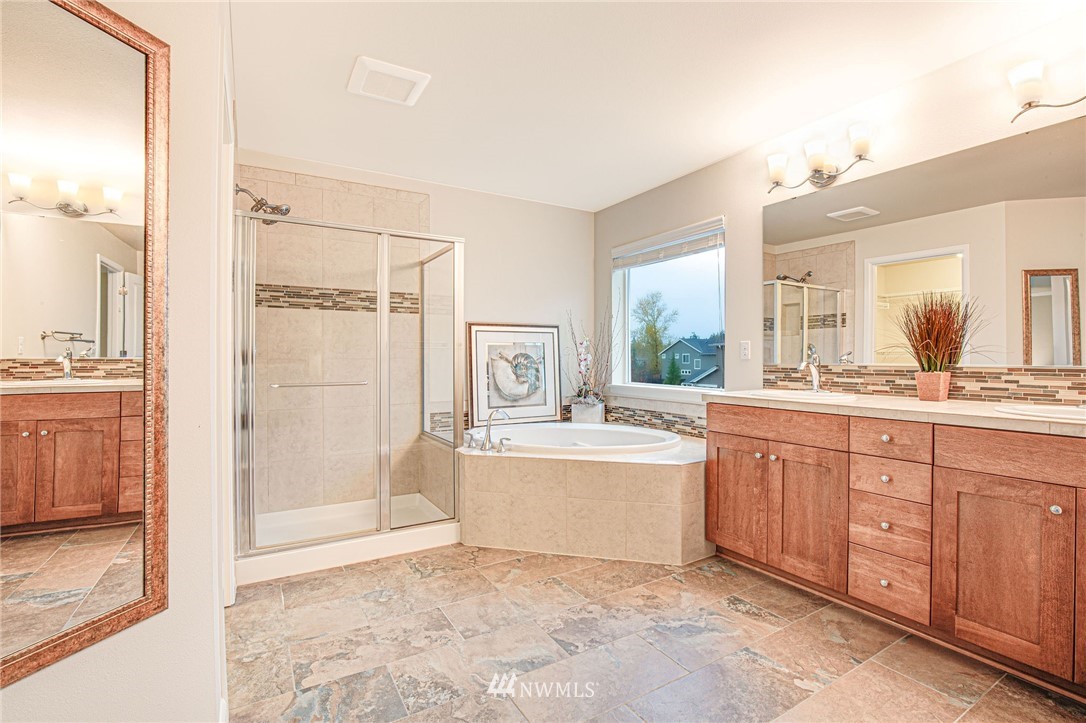 4025 181st Place Southeast Bothell, WA 98012 - Photo 12 of 26 a large bathroom with a tub sink and mirror