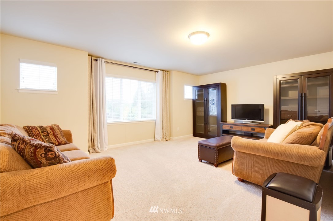 4025 181st Place Southeast Bothell, WA 98012 - Photo 16 of 26 a living room with furniture and a flat screen tv