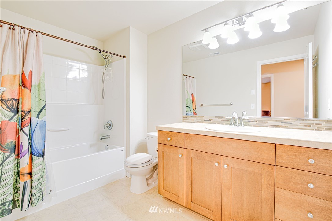 4025 181st Place Southeast Bothell, WA 98012 - Photo 17 of 26 a bathroom with a granite countertop sink a toilet and shower