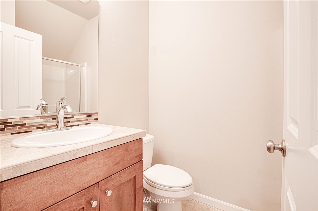 4025 181st Place Southeast Bothell, WA 98012 - Photo 18 of 26 a bathroom with a sink a toilet and mirror