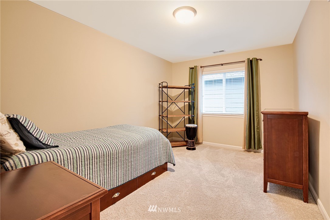 4025 181st Place Southeast Bothell, WA 98012 - Photo 19 of 26 a bedroom with a bed and gym equipment