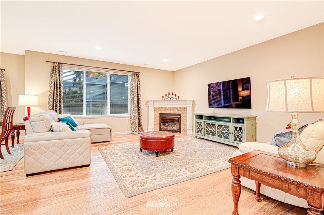 4025 181st Place Southeast Bothell, WA 98012 - Photo 7 of 26 a living room with fireplace furniture and a flat screen tv