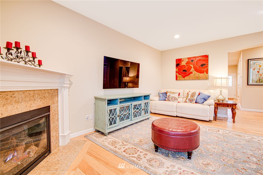 4025 181st Place Southeast Bothell, WA 98012 - Photo 8 of 26 a living room with furniture and a fireplace