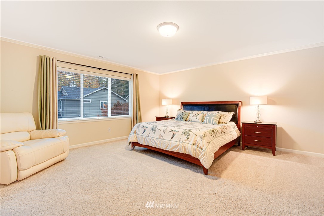 4025 181st Place Southeast Bothell, WA 98012 - Photo 9 of 26 a bedroom with a bed and a large window