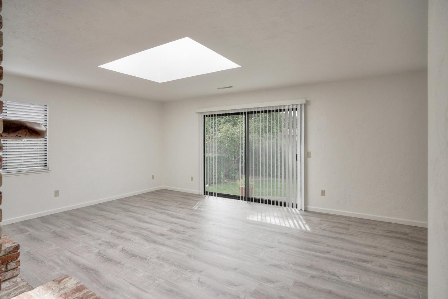 26419 Oliver Road Carmel, CA 93923 - Photo 12 of 35 an empty room with wooden floor and windows