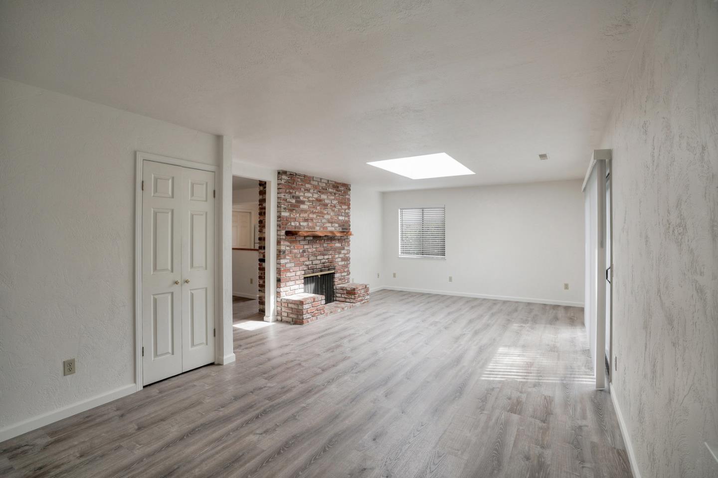 26419 Oliver Road Carmel, CA 93923 - Photo 13 of 35 a view of empty room with wooden floor and fireplace