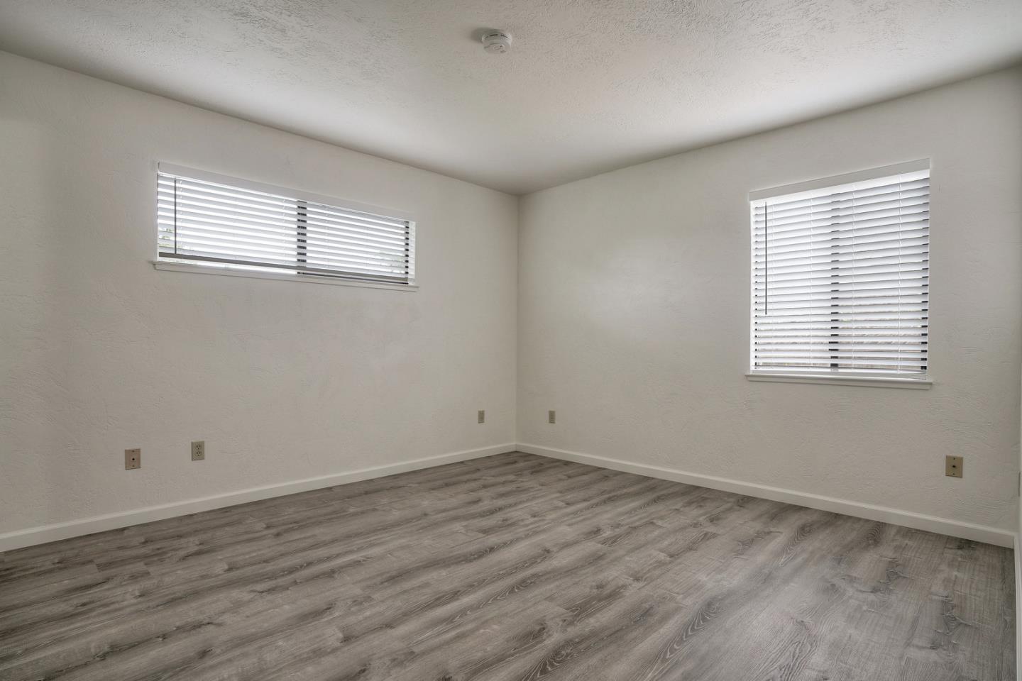 26419 Oliver Road Carmel, CA 93923 - Photo 20 of 35 a view of a room with wooden floor and windows