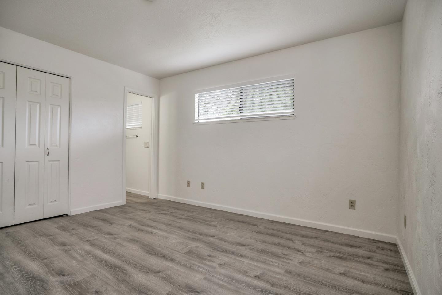 26419 Oliver Road Carmel, CA 93923 - Photo 21 of 35 a view of an empty room with wooden floor