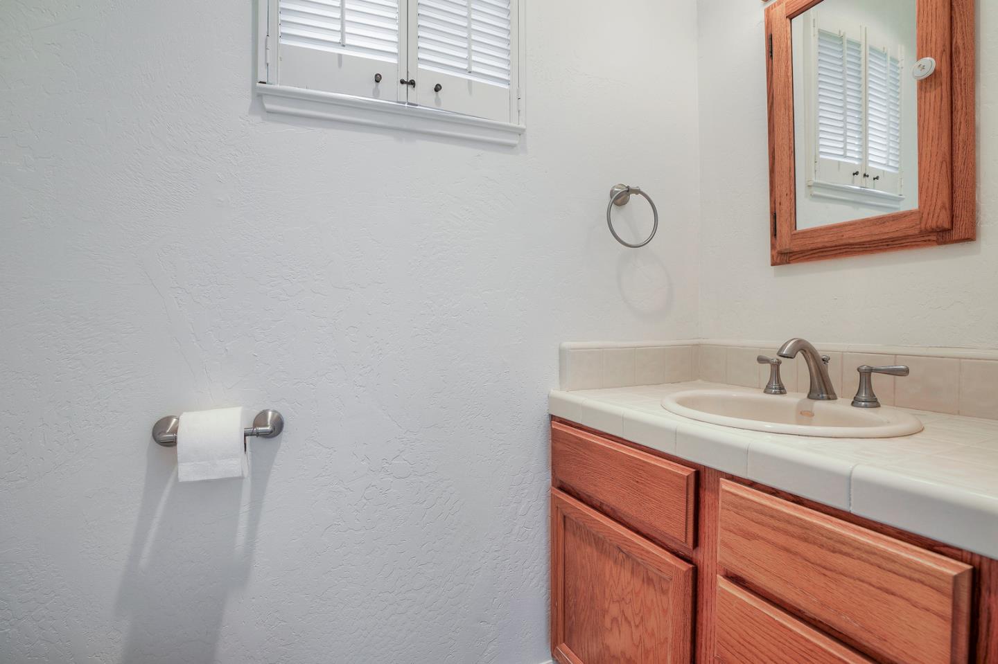 26419 Oliver Road Carmel, CA 93923 - Photo 27 of 35 a bathroom with a sink and a mirror