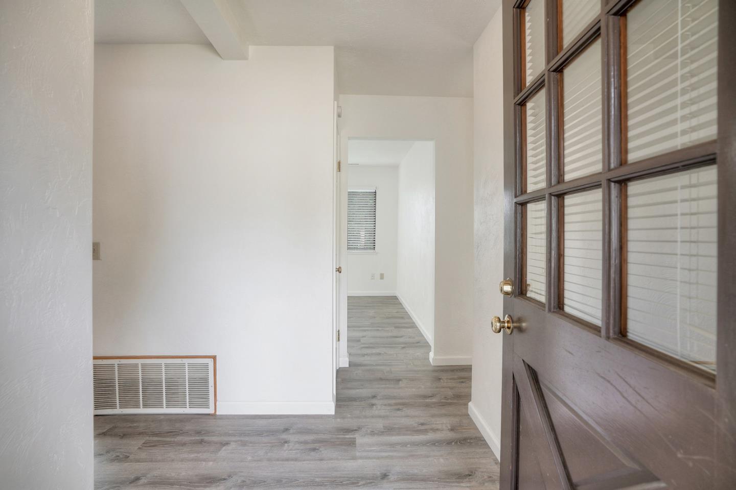 26419 Oliver Road Carmel, CA 93923 - Photo 6 of 35 a view of a hallway with wooden floor and windows