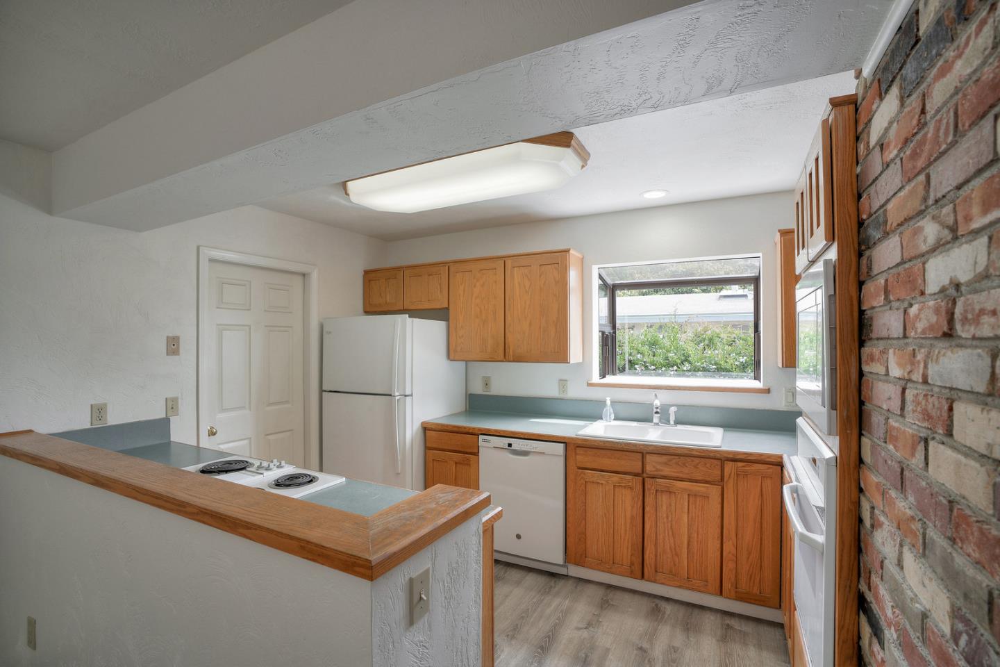 26419 Oliver Road Carmel, CA 93923 - Photo 9 of 35 a kitchen with a sink stove and refrigerator