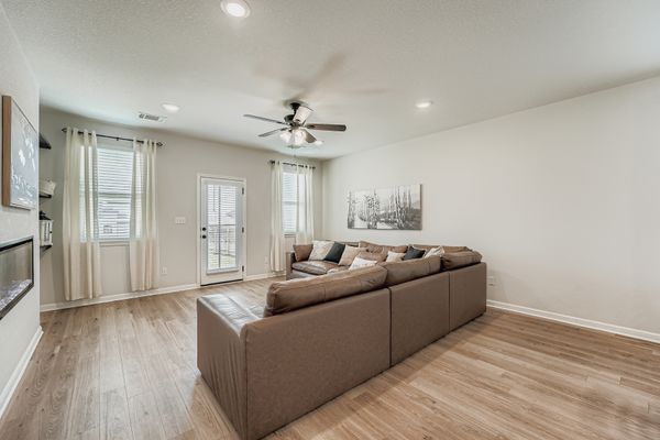 148 Gullivers Drive Elgin, TX 78621 - Photo 4 of 21 Living room featuring ceiling fan, light wood-style floors, and recessed lighting