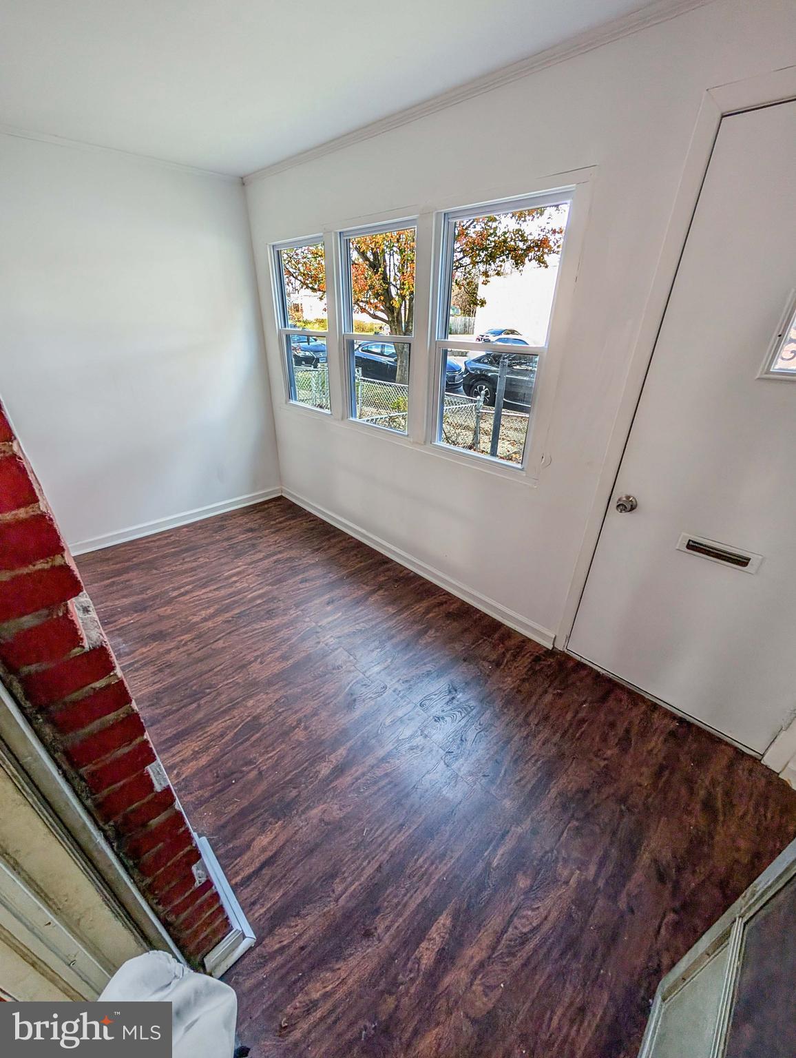 414 Avondale Road Dundalk, MD 21222 - Photo 12 of 17 a view of an empty room with wooden floor and a window