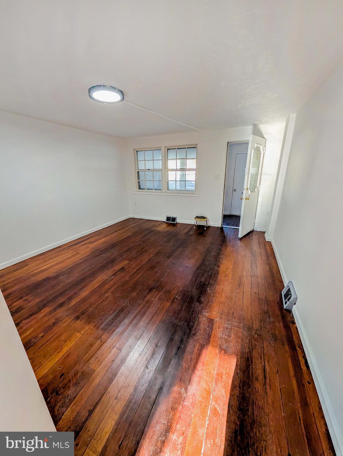 414 Avondale Road Dundalk, MD 21222 - Photo 5 of 17 a view of a bedroom with wooden floor and window