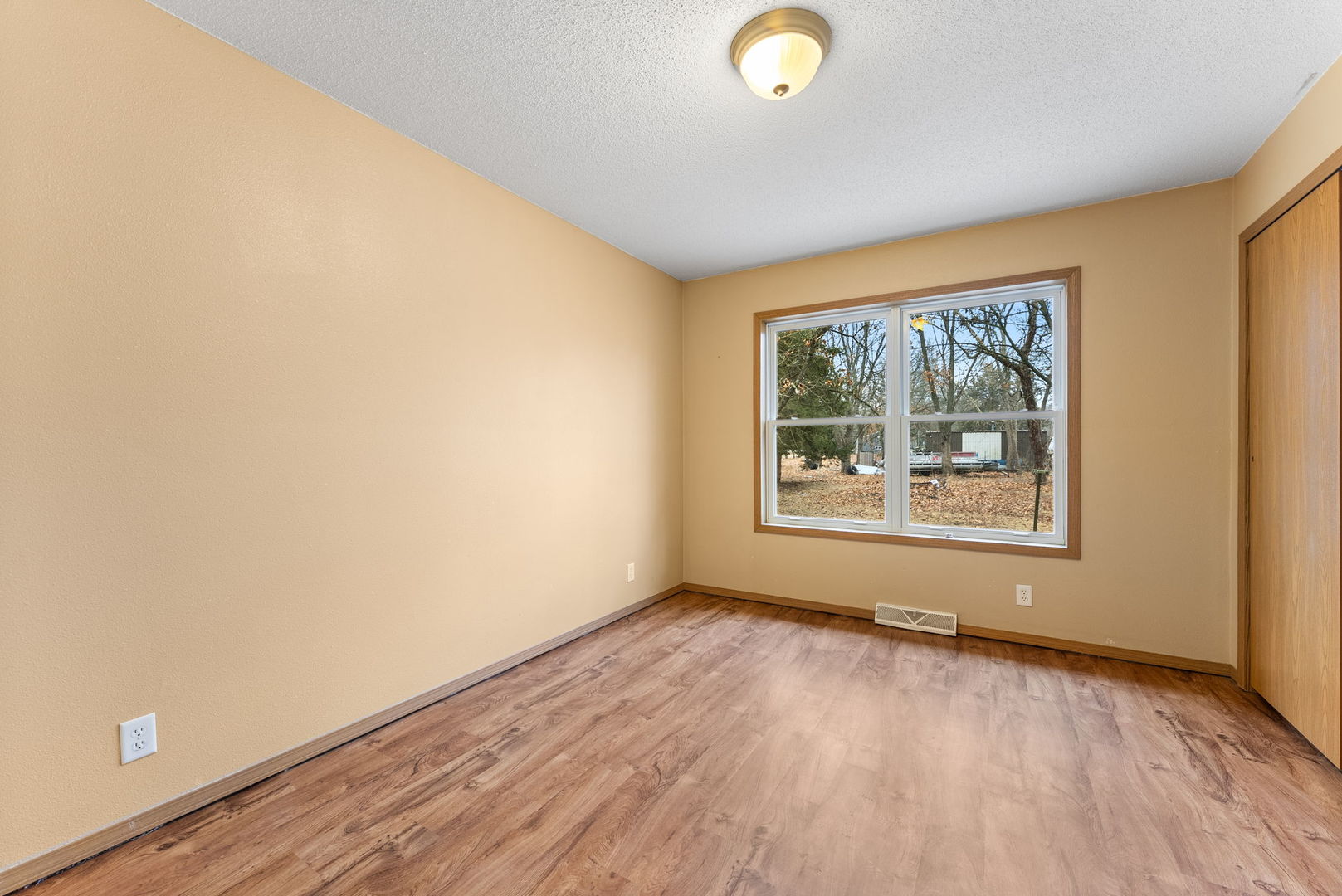 449 83rd Avenue New Boston, IL 61272 - Photo 14 of 25 an empty room with wooden floor and windows
