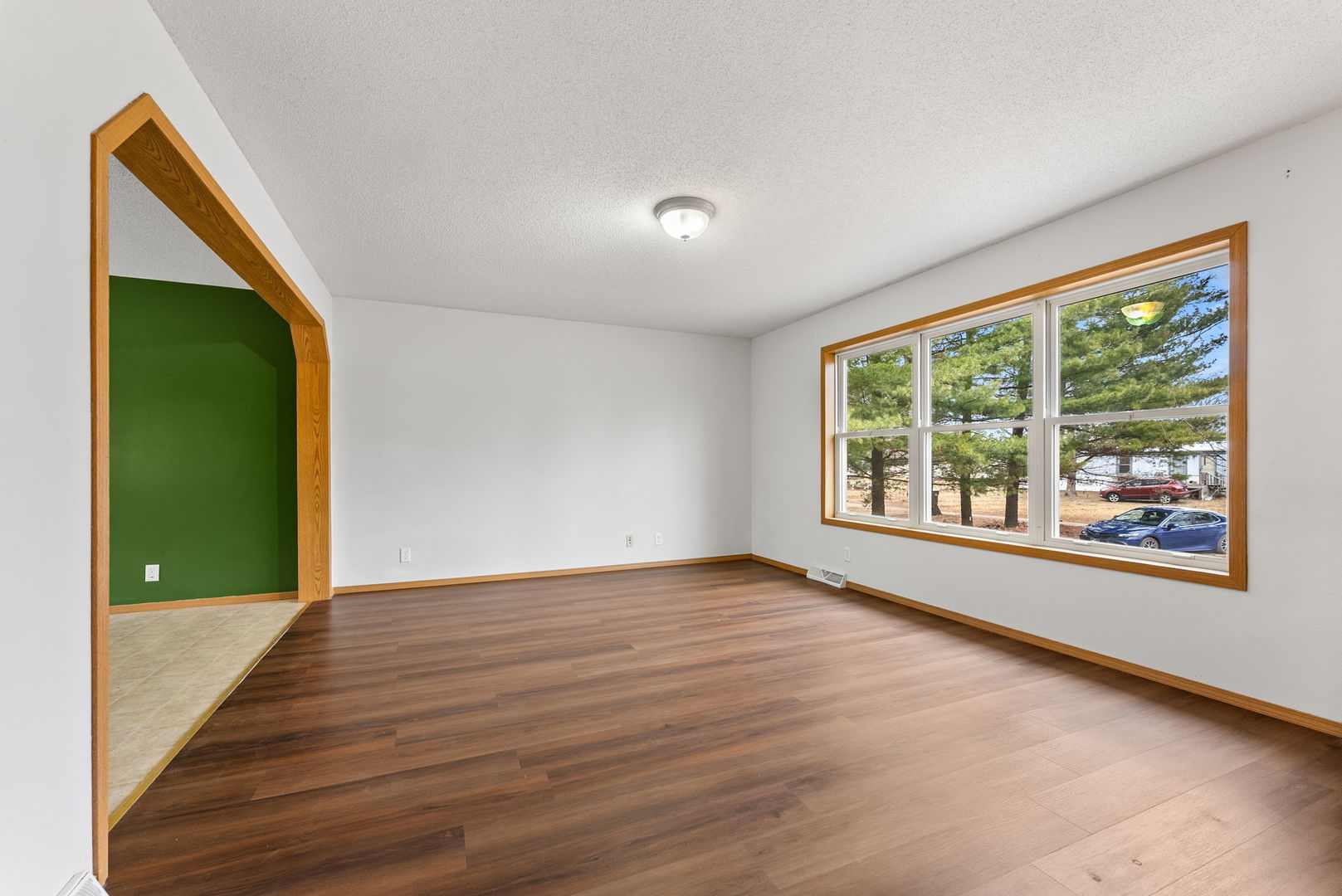 449 83rd Avenue New Boston, IL 61272 - Photo 6 of 25 a view of an empty room with wooden floor and a window