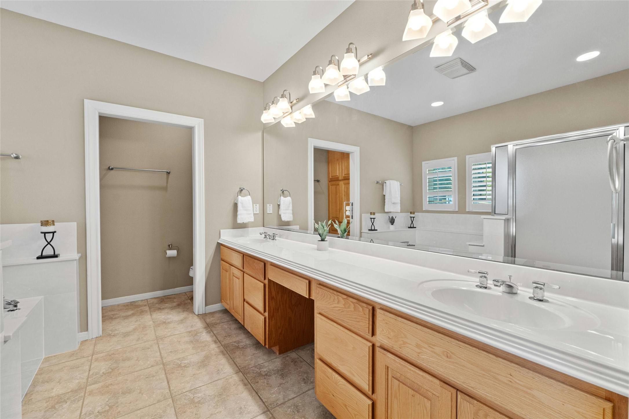 209 Overlook Court Georgetown, TX 78628 - Photo 21 of 34 a spacious bathroom with a granite countertop sink a large mirror and a shower