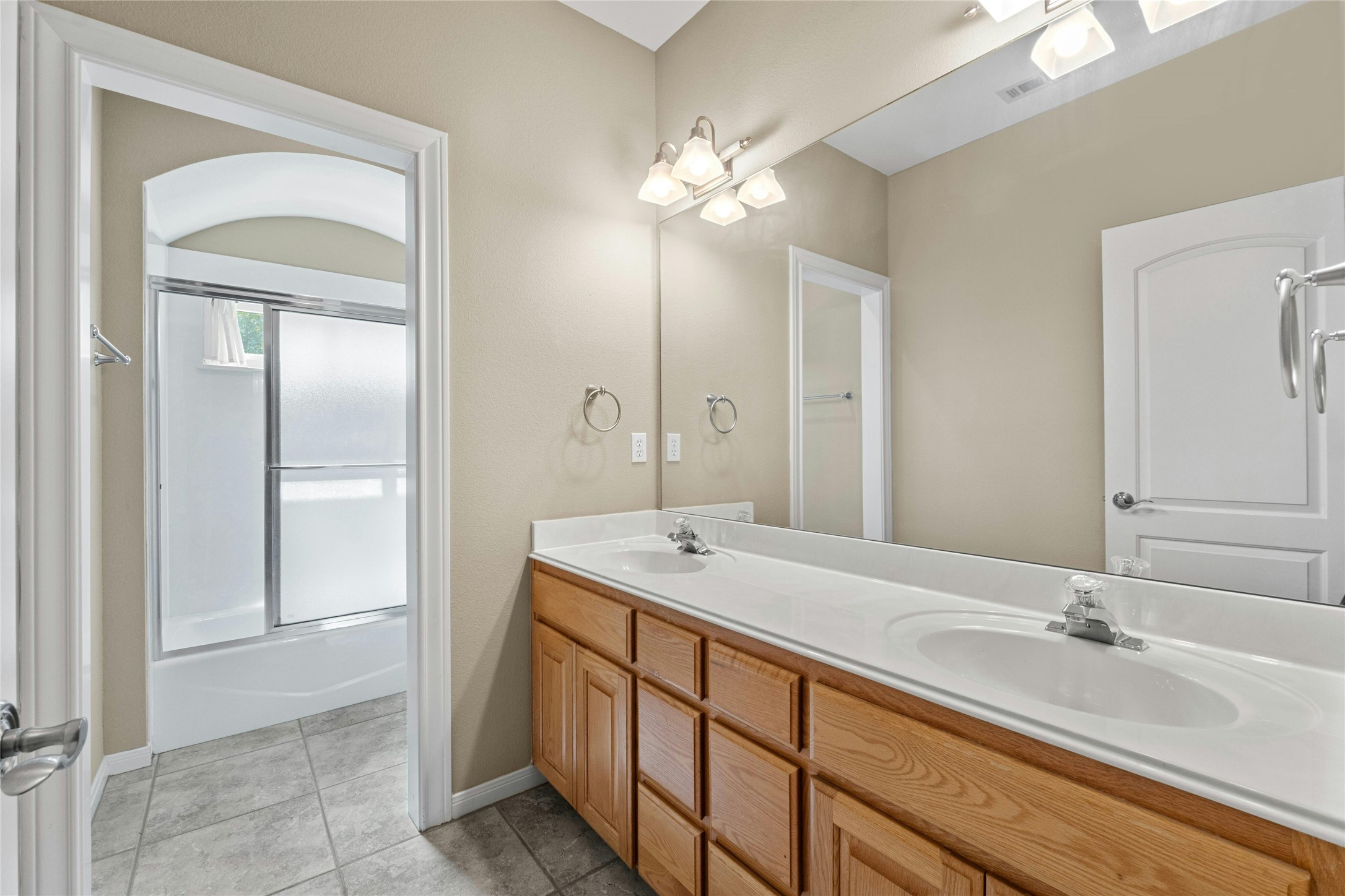 209 Overlook Court Georgetown, TX 78628 - Photo 27 of 34 a spacious bathroom with a granite countertop sink a light fixture and a mirror