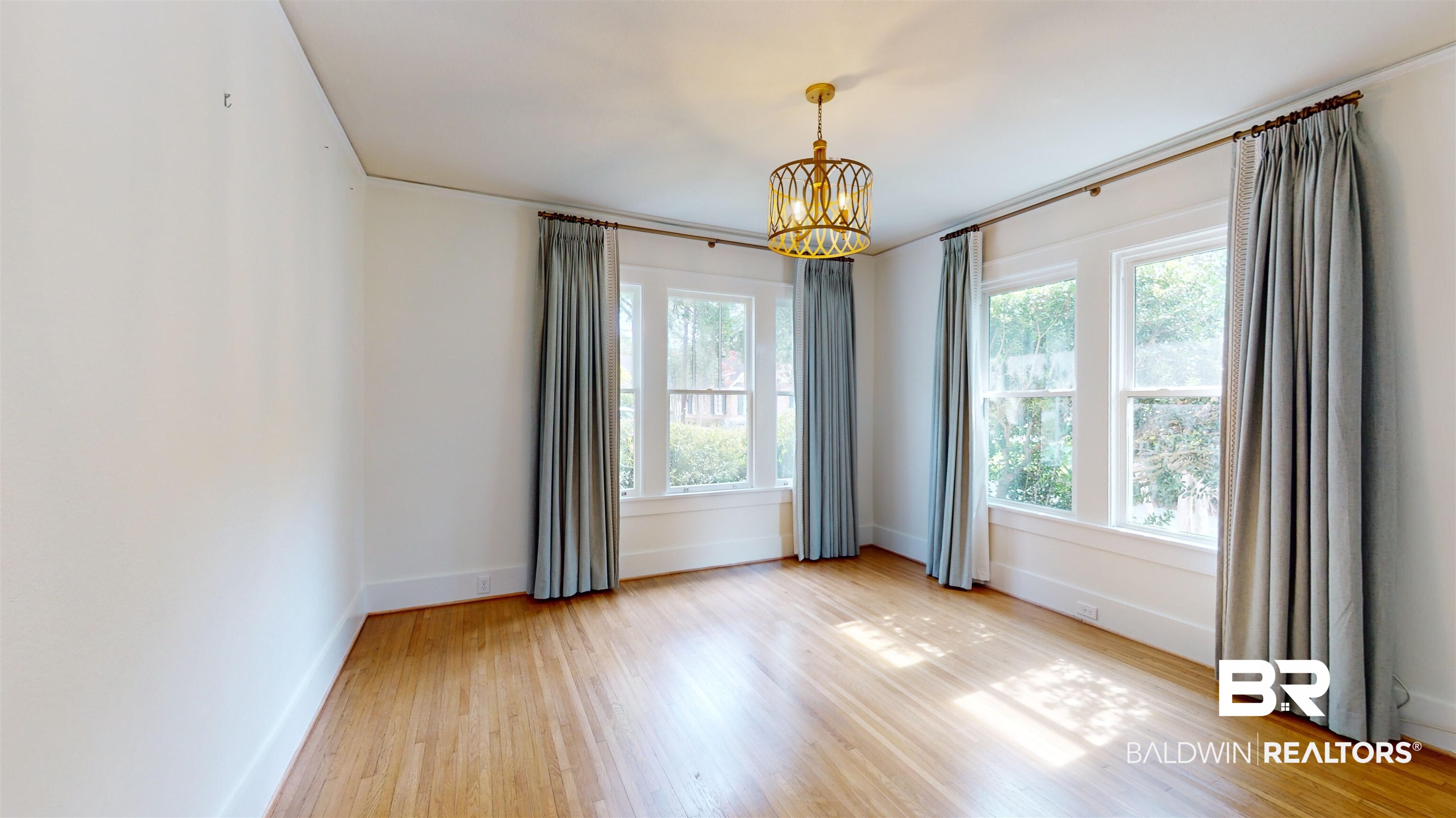 4307 Stein Street Mobile, AL 36608 - Photo 13 of 28 Empty room with plenty of natural light, an inviting chandelier, and light hardwood / wood-style floors