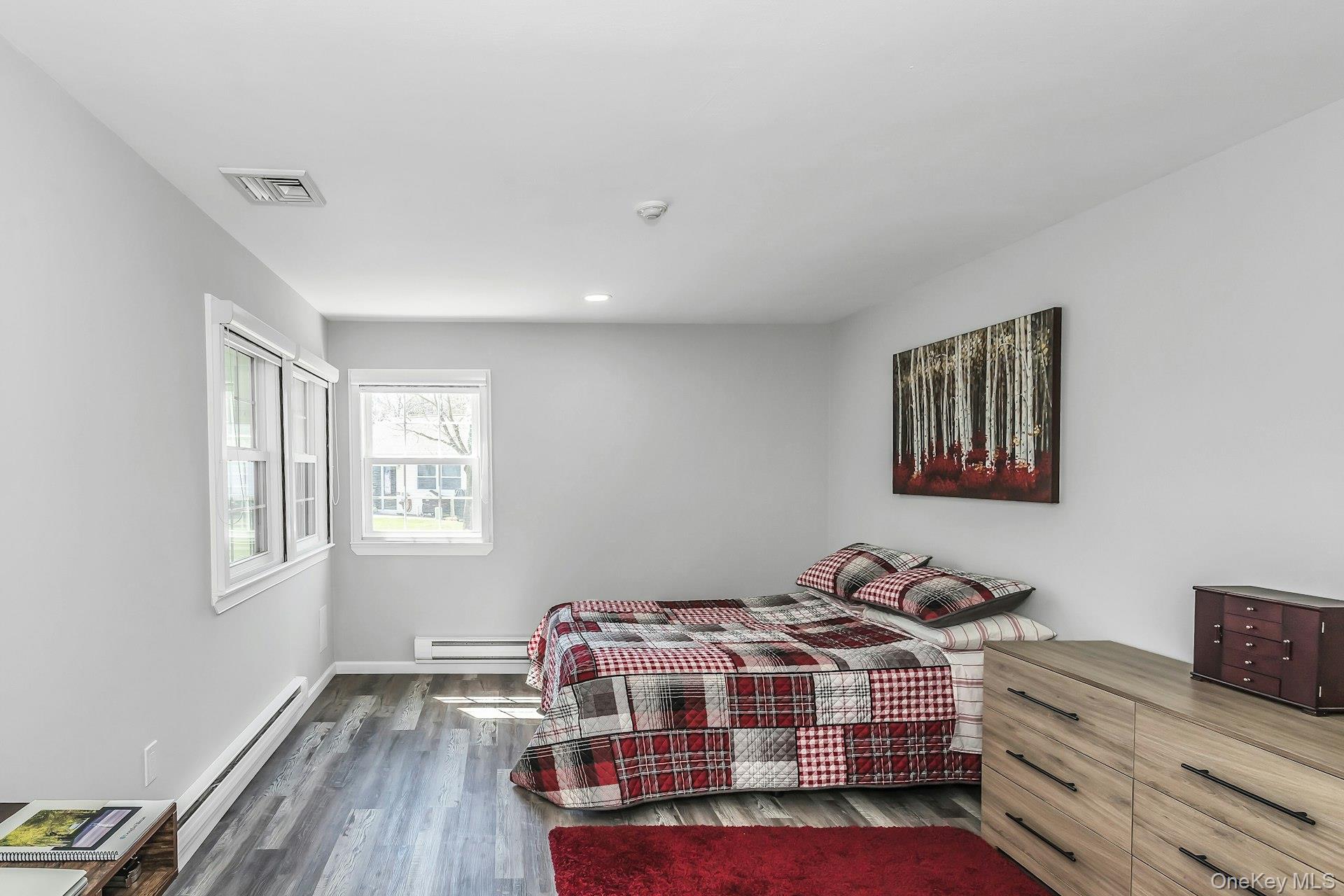 55 Forge Lane Coram, NY 11784 - Photo 12 of 28 a bedroom with a bed and wooden floor