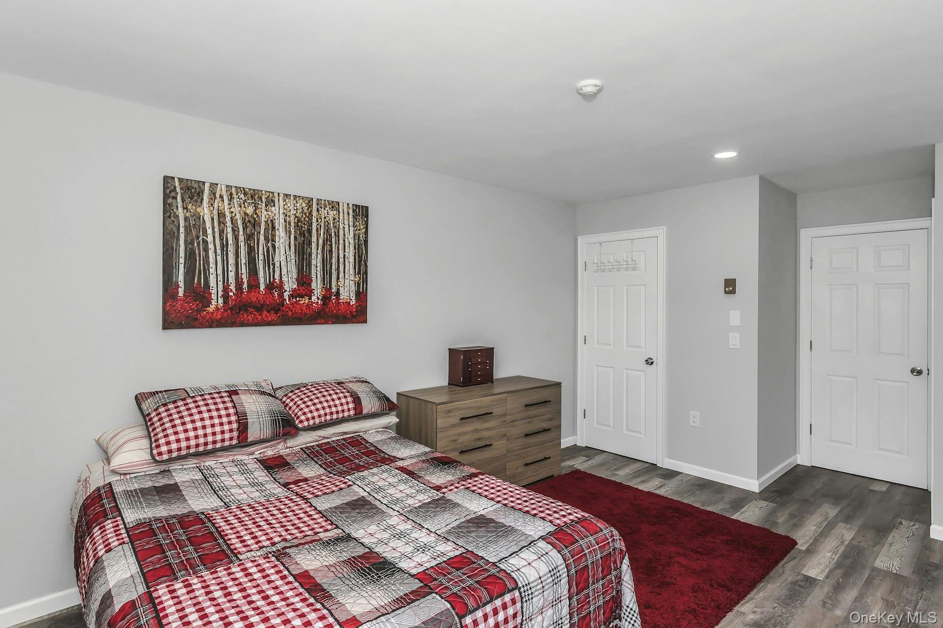55 Forge Lane Coram, NY 11784 - Photo 13 of 28 a bedroom with a bed and wooden floor