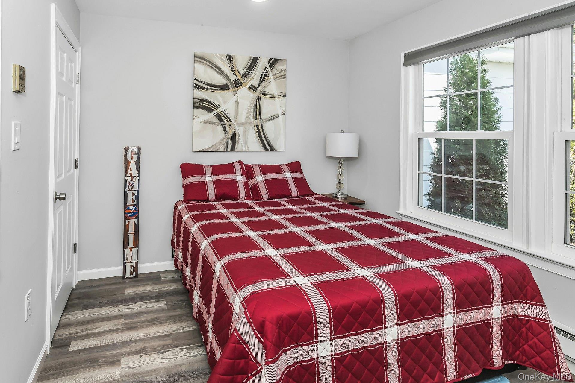 55 Forge Lane Coram, NY 11784 - Photo 14 of 28 a bedroom with a bed and wooden floor