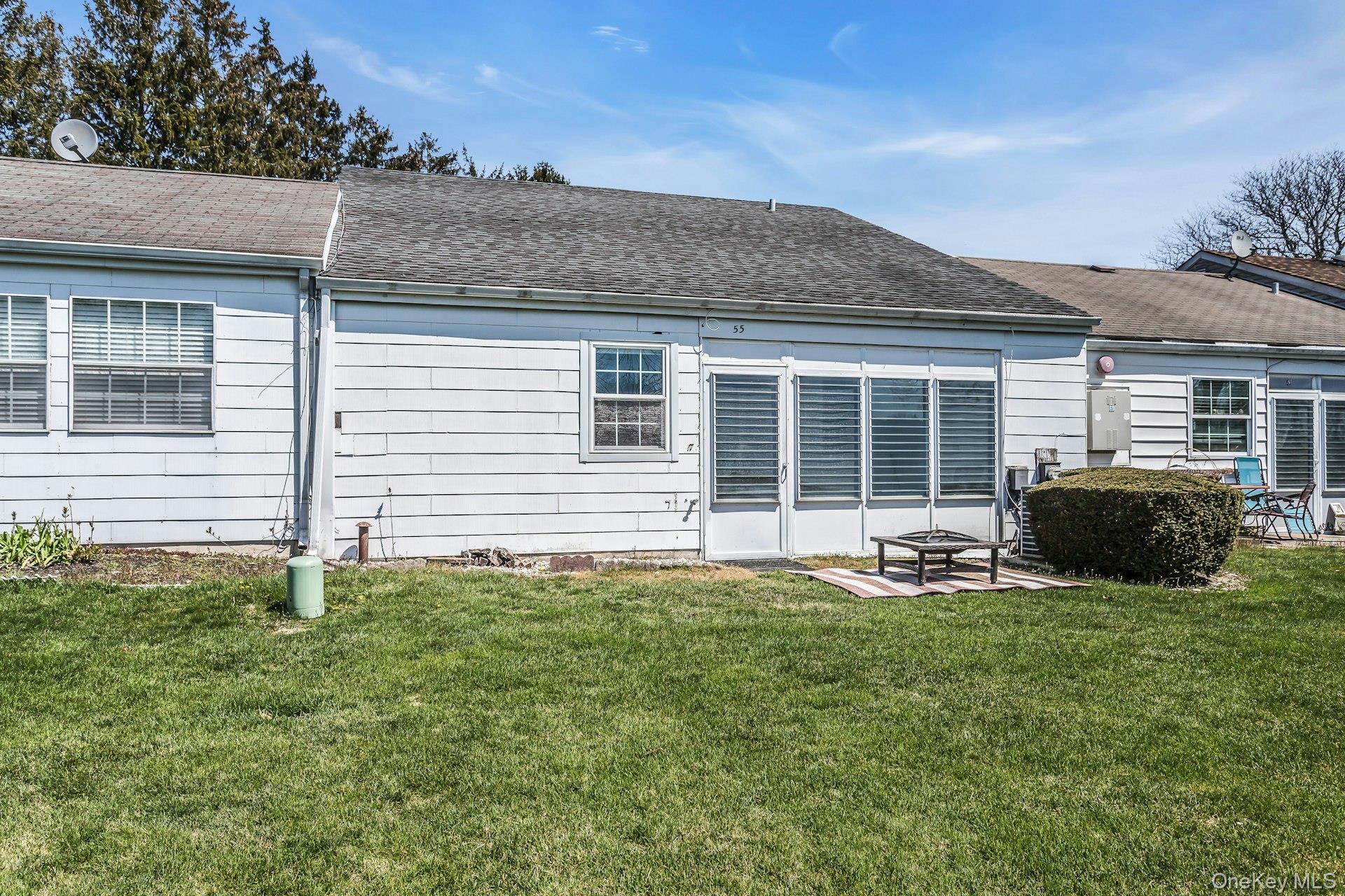 55 Forge Lane Coram, NY 11784 - Photo 17 of 28 a view of a house with a yard and sitting area