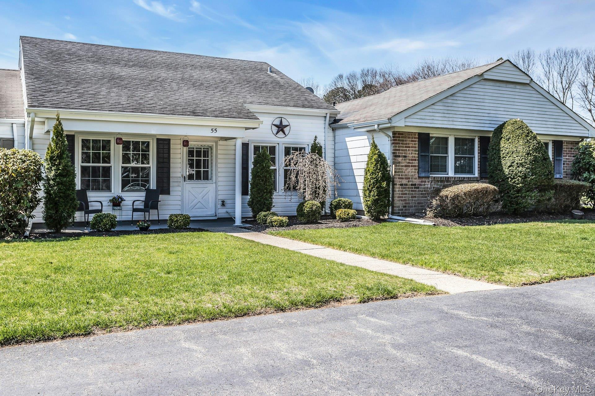 55 Forge Lane Coram, NY 11784 - Photo 2 of 28 front view of a house with a yard and porch