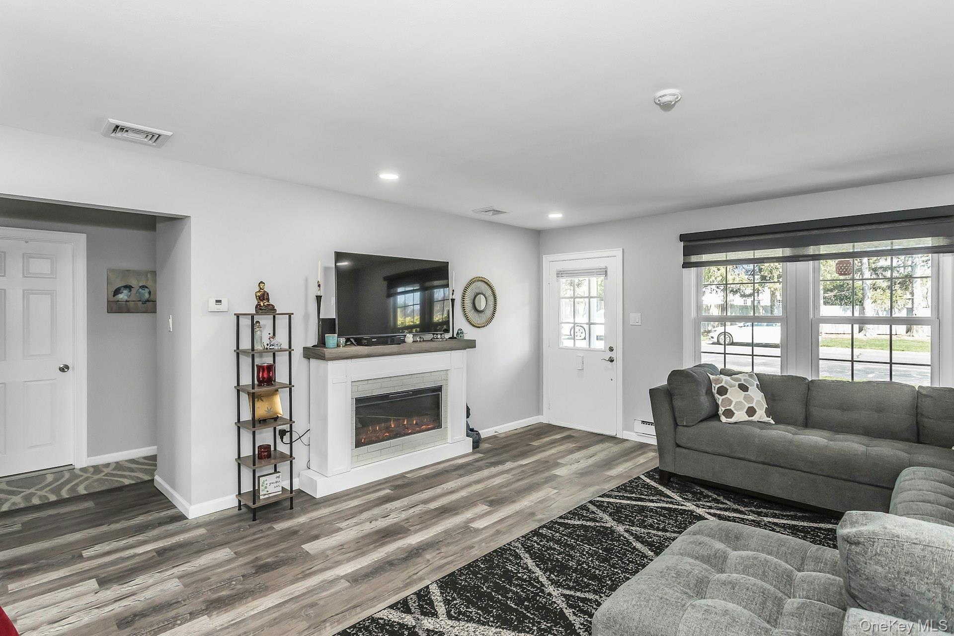 55 Forge Lane Coram, NY 11784 - Photo 5 of 28 a living room with furniture and a fireplace