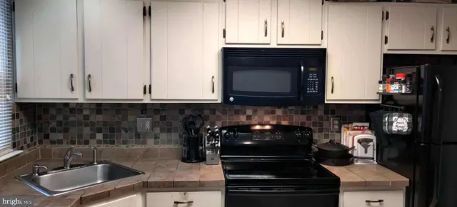a kitchen with a sink and cabinets