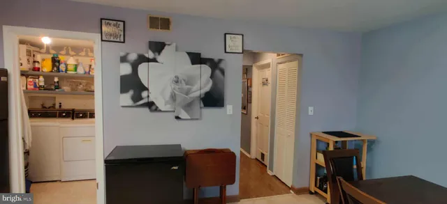 a view of hallway with wooden floor