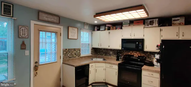 a kitchen with a sink appliances and cabinets