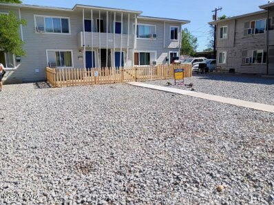 a front view of a house with outdoor seating