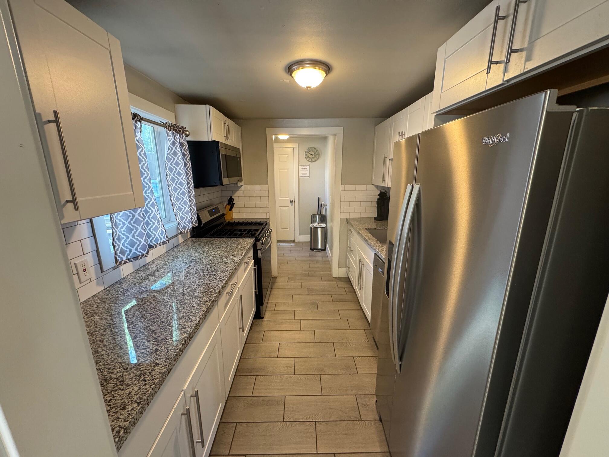 565 Denslowe Drive Reno, NV 89512 - Photo 9 of 26 a kitchen with stainless steel appliances granite countertop a refrigerator and a stove