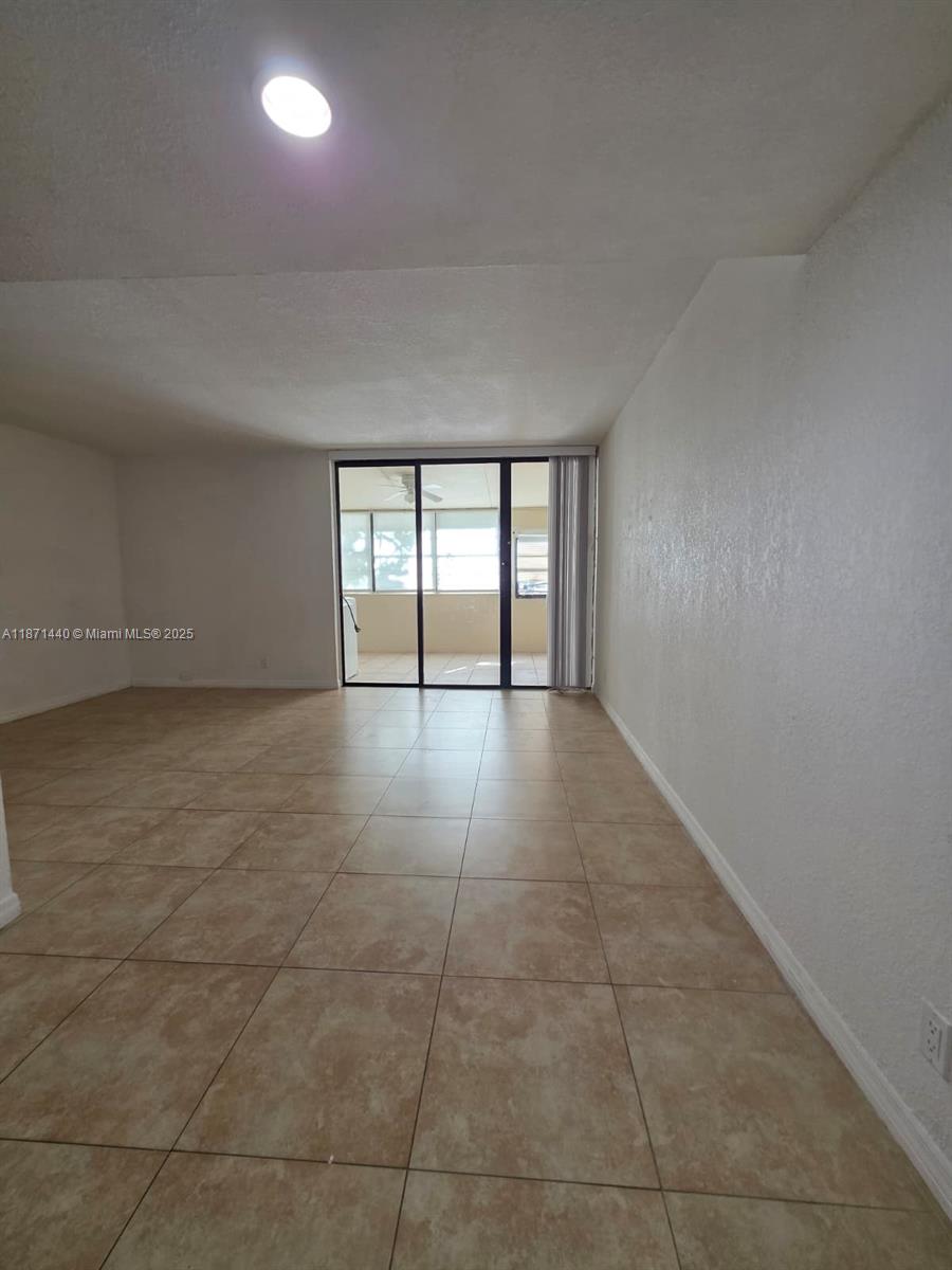 20200 West Country Club Drive, Unit 104 Aventura, FL 33180 - Photo 12 of 43 a view of an empty room with a window