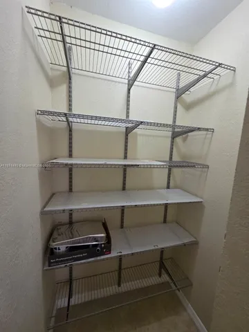 a bathroom with a granite countertop toilet and a sink