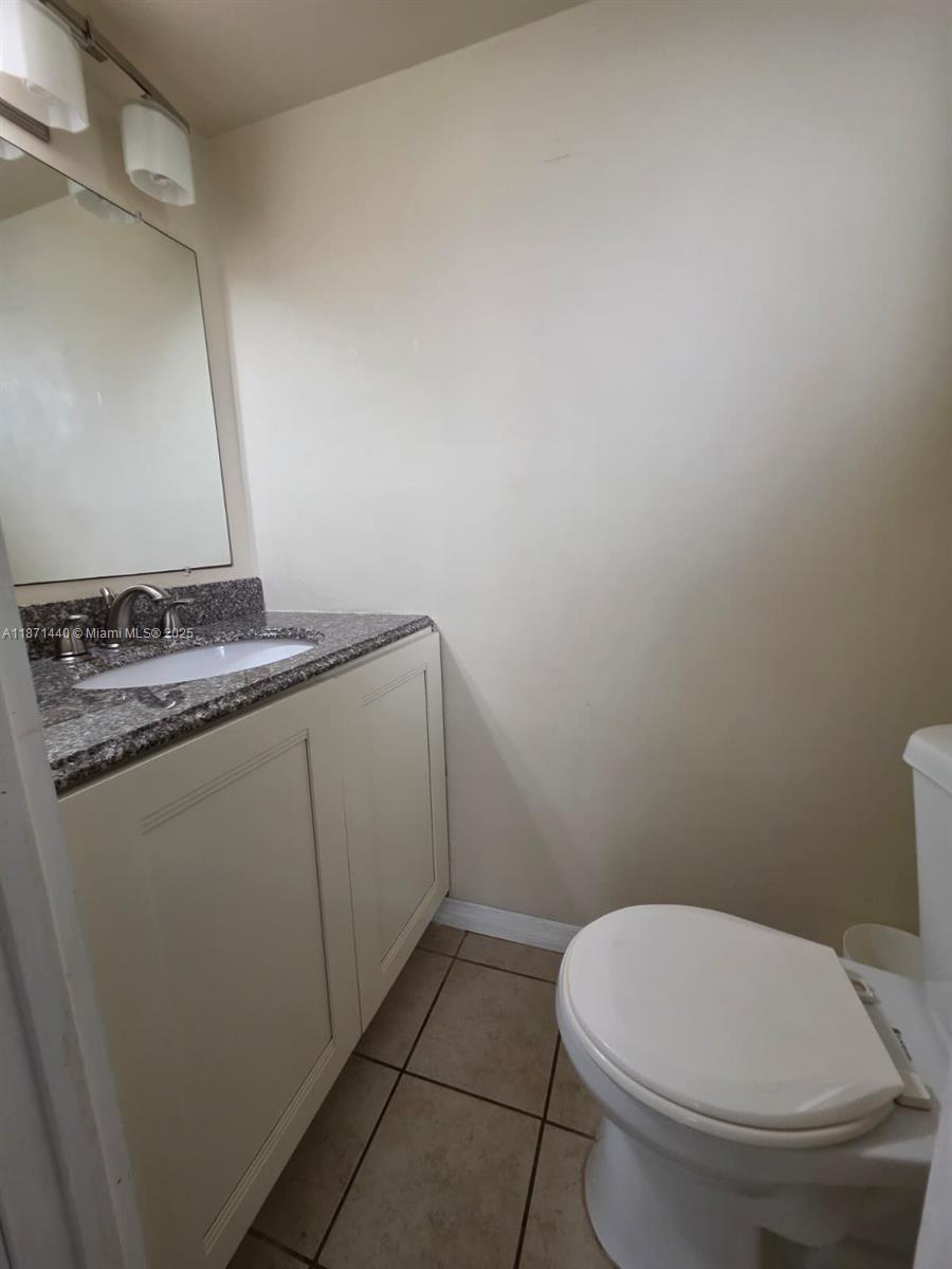 20200 West Country Club Drive, Unit 104 Aventura, FL 33180 - Photo 15 of 43 a bathroom with a granite countertop toilet and a sink