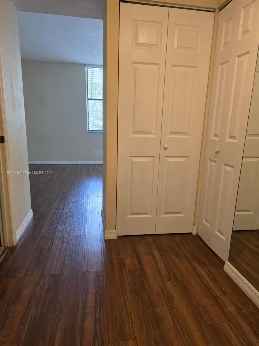 20200 West Country Club Drive, Unit 104 Aventura, FL 33180 - Photo 18 of 43 wooden floor in an empty room