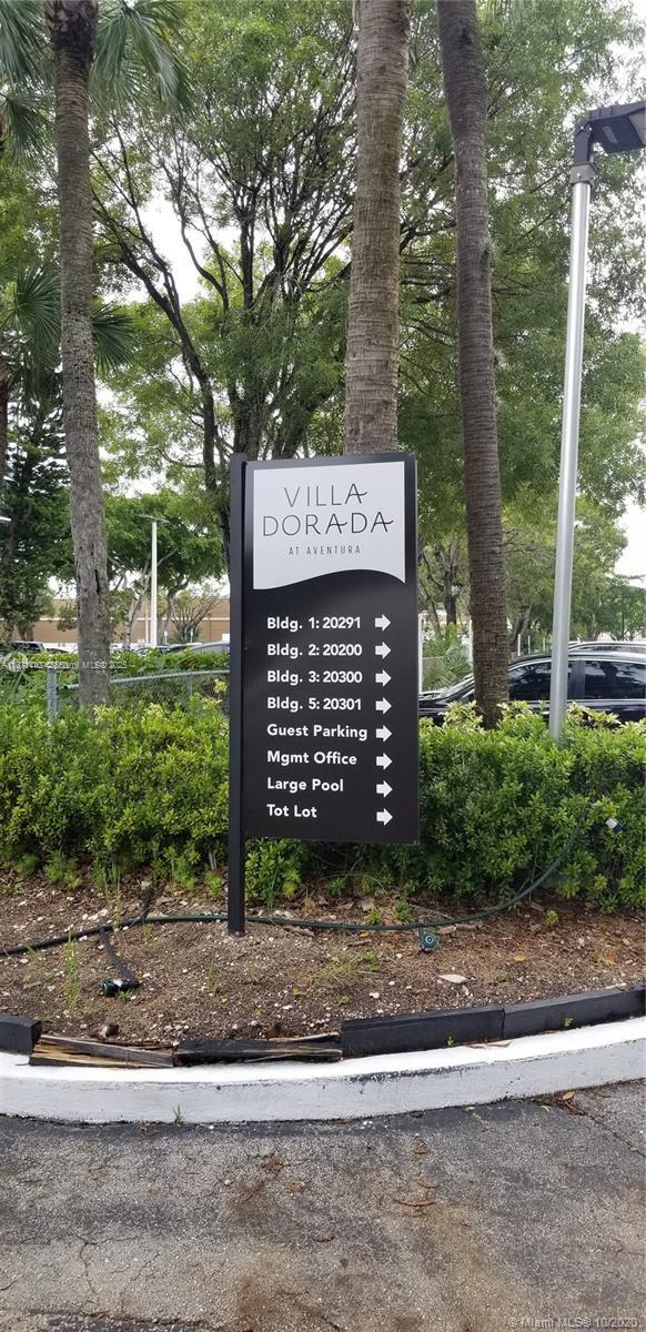 20200 West Country Club Drive, Unit 104 Aventura, FL 33180 - Photo 2 of 43 a sign on the side of a road