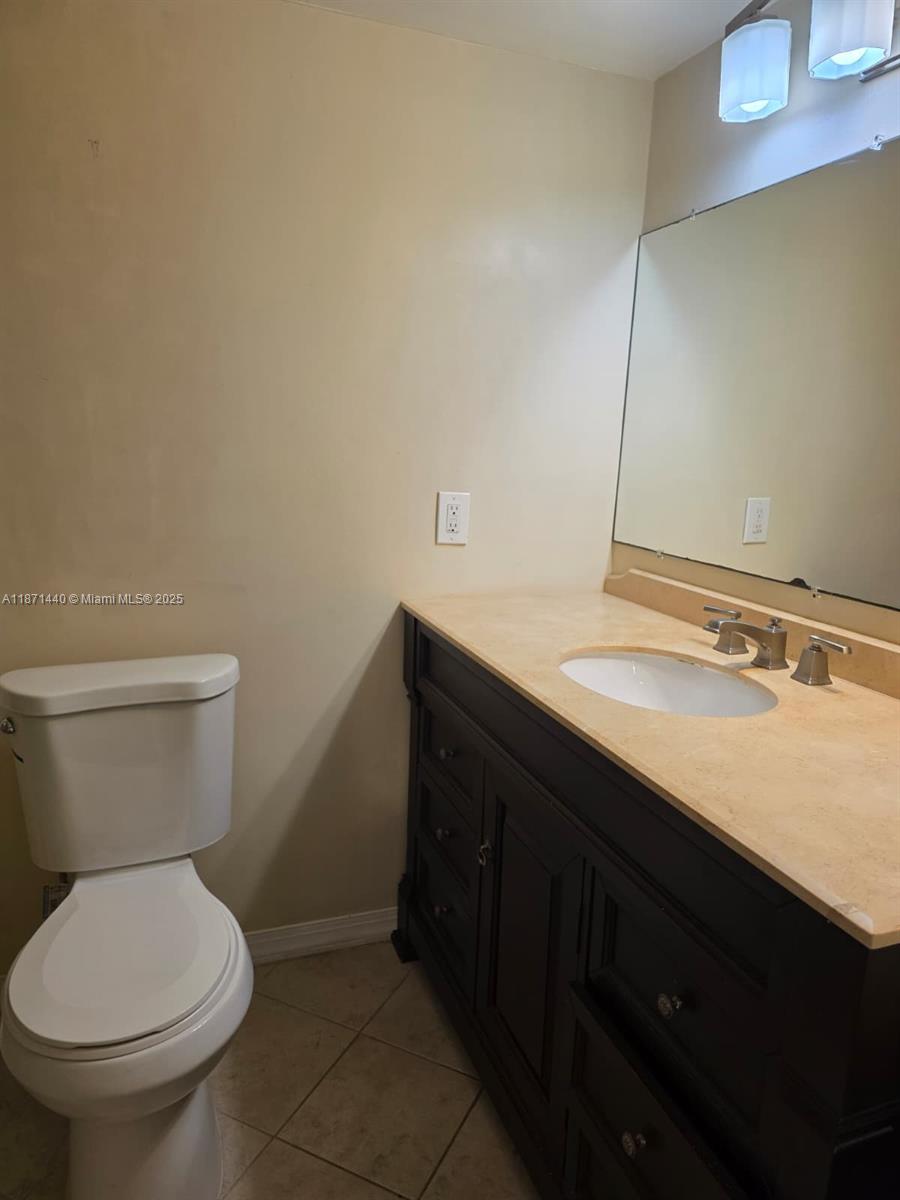 20200 West Country Club Drive, Unit 104 Aventura, FL 33180 - Photo 26 of 43 a bathroom with a sink and a toilet