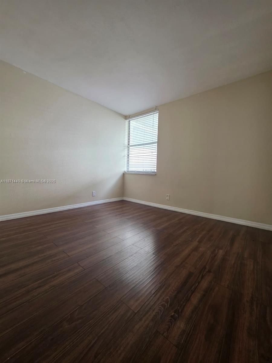 20200 West Country Club Drive, Unit 104 Aventura, FL 33180 - Photo 29 of 43 a view of wooden floor and windows in a room