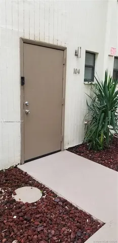a bedroom with a bed and a potted plant