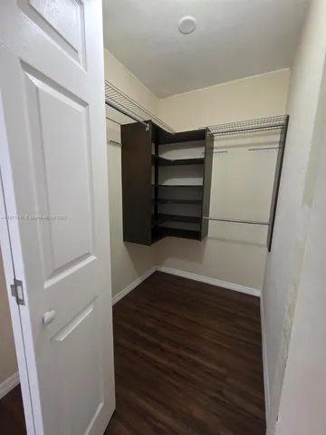 a view of walk in closet with empty racks