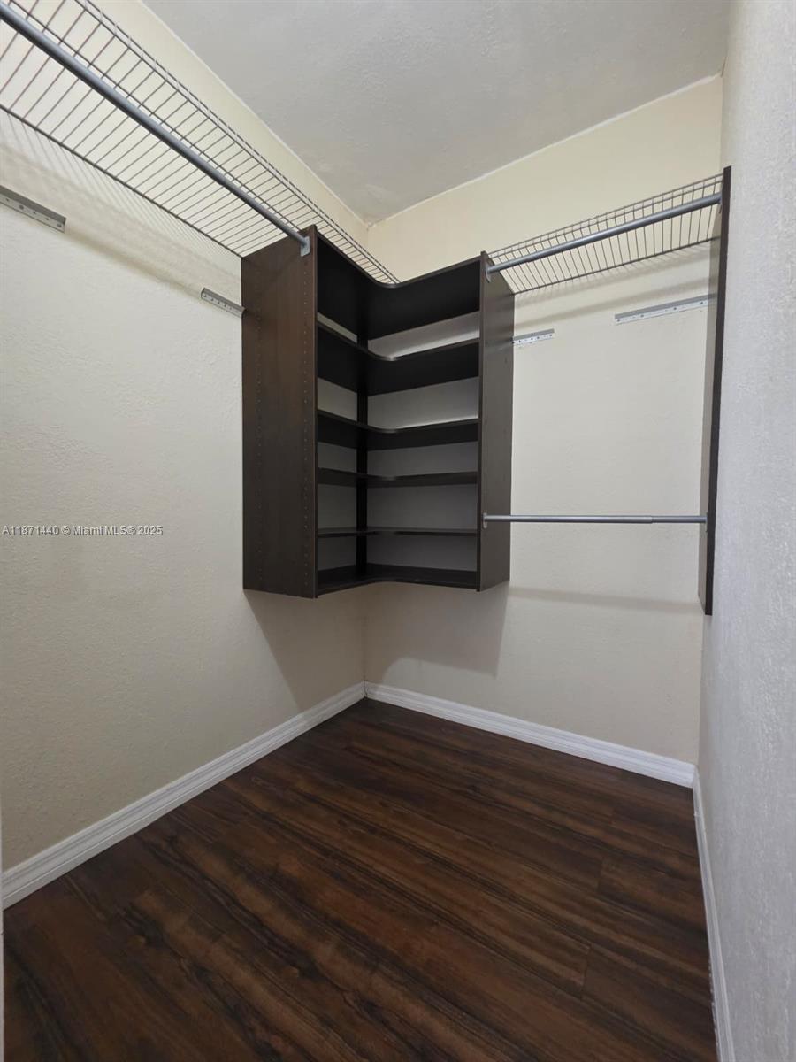 20200 West Country Club Drive, Unit 104 Aventura, FL 33180 - Photo 32 of 43 a view of walk in closet with empty racks