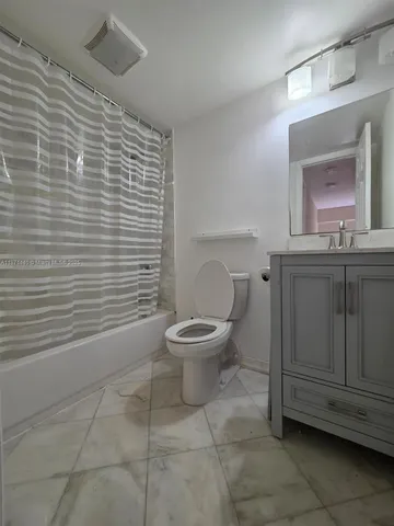 a bathroom with a sink toilet and mirror