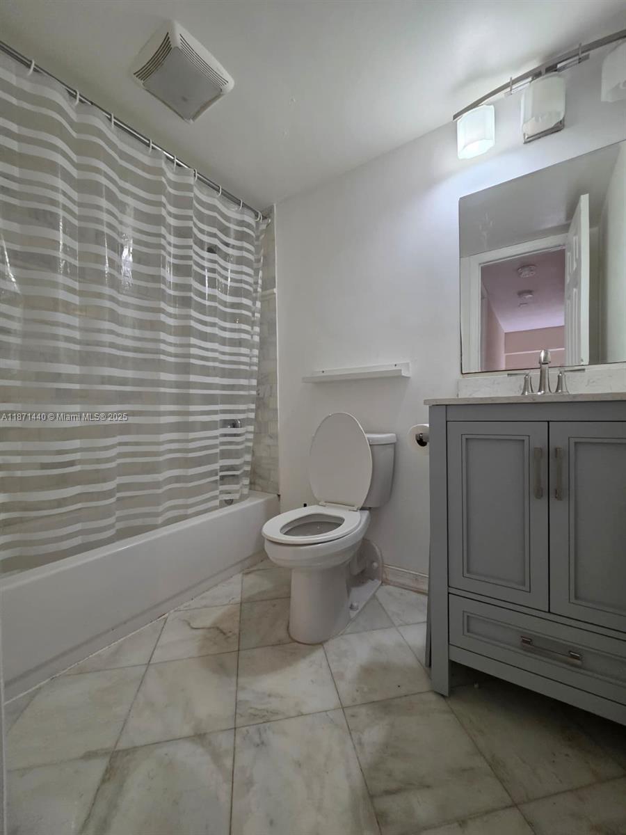 20200 West Country Club Drive, Unit 104 Aventura, FL 33180 - Photo 33 of 43 a bathroom with a toilet a sink and mirror