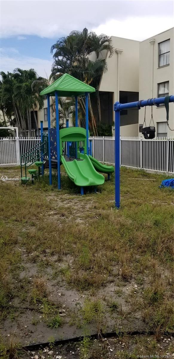 20200 West Country Club Drive, Unit 104 Aventura, FL 33180 - Photo 40 of 43 a view of a deck with a yard